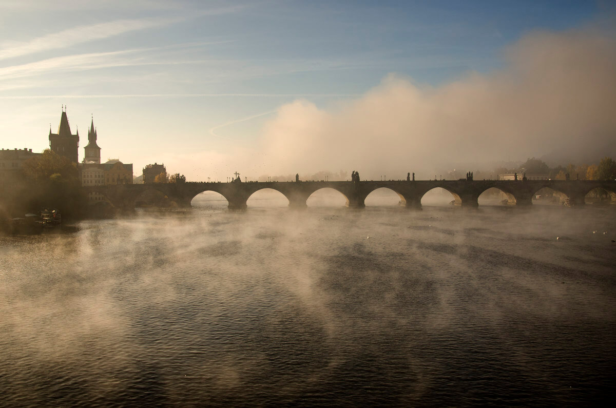 Mist over the Vltava River and Charles Bridge in Prague.